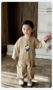 Detail of toddler boy two-piece cotton set with panda print and striped sleeves