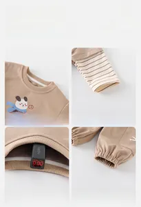 Detail view of khaki cotton toddler tracksuit featuring ribbed cuffs and safety test results