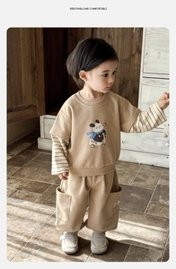 Detail of toddler boy khaki tracksuit set with panda print and striped sleeve design