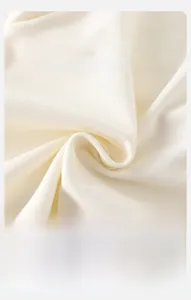 Gros plan sur le tissu en maille beige doux montrant la texture respirante pour bébé