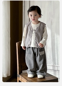 Detail of boys' 3-piece set with brown plaid vest, white bear t-shirt, and grey cargo pants