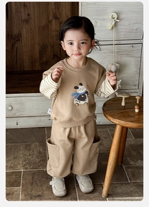 Detail of baby boy tracksuit with panda print, faux two-piece design and side pockets