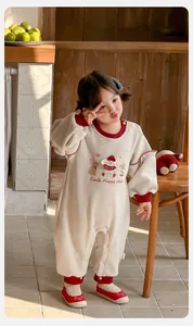 Close-up of baby romper showing cartoon embroidery and ruffled sleeve details