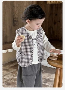 Close-up of boys three-piece set featuring purple plaid vest and cartoon bear t-shirt