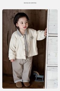 Three-piece baby boy clothing set with cardigan, checkered shirt, and khaki trousers