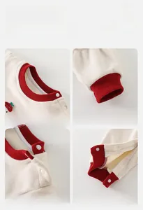 Detail view of cotton baby romper featuring strawberry embroidery and ribbed cuffs