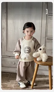 Close-up of baby boy tracksuit with cartoon puppy embroidery and soft cotton fabric