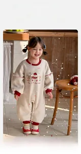 Detail of baby girl fleece bodysuit featuring cute rabbit embroidery and red ribbed cuffs