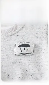 Detail of grey baby sweatshirt featuring ribbed neckline and cute cloud Rain Day applique