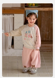 Detail of baby girl casual lounge set featuring cartoon bear prints and raglan sleeves