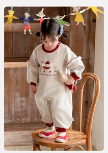 Detail of baby girl bodysuit featuring dog embroidery and ribbed red cuffs