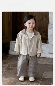 Detail view of baby boy's cotton jacket set with beige coat and dark grey cargo pants