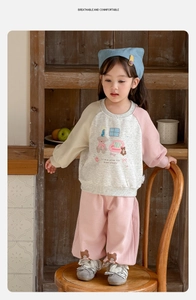 Detail of waffle knit toddler outfit with cartoon bear print and bicolor raglan sleeves