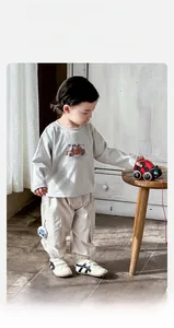 Detail of baby boy's beige car print long sleeve tee and khaki cargo pants set