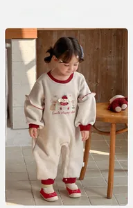 Macro shot of infant girl romper with cute animal prints and ruffled shoulder details