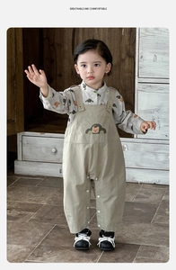 Detail of baby boy cartoon bear print shirt with stylish khaki overall pants set