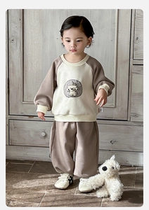 Detail view of cotton toddler sports set with raglan sleeves and cute dog embroidery