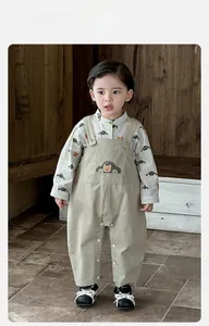 Detail of toddler car and bear print shirt paired with khaki suspender pants set