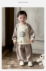 Detail of baby boy sporty raglan sweatshirt and joggers set with puppy patch embroidery