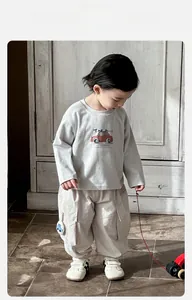 Detail of baby boy grey cotton sweatshirt with red car print and matching cargo pants