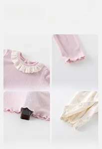 Detail of pink knitted baby top showing lace collar, windproof cuffs and safe fabric