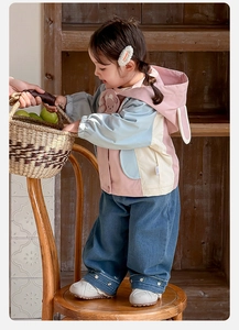 Detail of girls hooded patchwork jacket with bunny ears and floral embroidery jeans