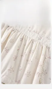Close-up of baby floral cotton fabric featuring delicate pleats and high-quality stitching