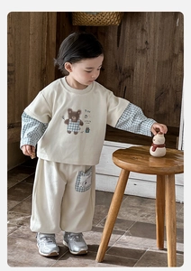 Detail of baby cream hoodie with checkered bear print and matching joggers set