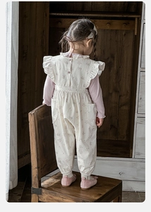 Detail of floral baby girl jumpsuit with ruffle sleeves and pink long sleeve top