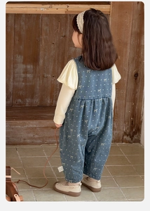 Close-up of baby girl polka dot denim overalls with ruffled long sleeve top set