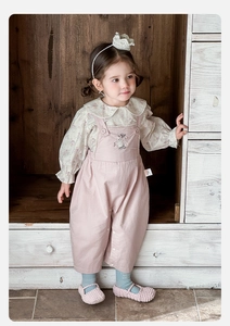 Detail of floral shirt lace collar and cute rabbit embroidery on pink overalls set