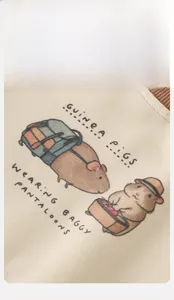 Detail of baby cream knit sweatshirt featuring a cute cartoon guinea pig graphic print
