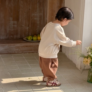 Toddler boy spring casual outfit featuring a beige sweatshirt and brown wide-leg pants