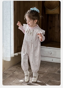 Detail of sweet pink long-sleeve baby bodysuit with ruffles and cute bear print