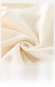 Macro detail of breathable and soft cream knit fabric for a baby sweatshirt set
