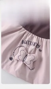 Detail of 3D stuffed butterfly and embroidery on girls pink and brown jacket