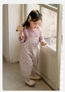 Close-up of cute rabbit embroidery on toddler floral overalls with purple shirt