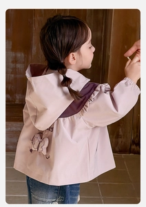 Detail of pink and purple windbreaker jacket for girls featuring a back bow and embroidery