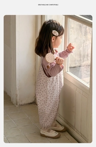 Detail of floral baby girl jumpsuit set with ruffled collar and soft cotton fabric