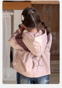 Close-up of baby girl's pink hoodie featuring 3D butterfly decor and artistic text on back