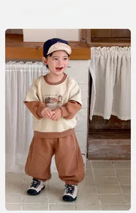Close-up of boys tracksuit set featuring cartoon capybara print and contrast stitching
