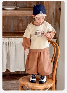 Detail view of retro beige and brown boy's guinea pig tracksuit set with joggers