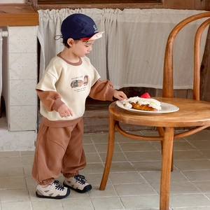 Casual toddler boy set with beige cartoon sweatshirt and brown joggers for spring