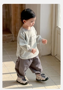 Detail view of baby boy green bear print sweatshirt and grey loose trousers set