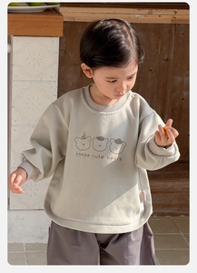 Detail of baby boy sweatshirt featuring cute three bears print and ribbed cuffs