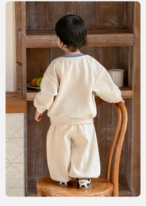 Rear view of infant boys cream cotton tracksuit featuring contrast blue ribbed collar detail
