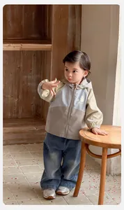 Détail de la veste à capuche tricolore pour bébé garçon avec motif cartoon et let's go
