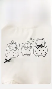 Close-up of cotton baby sweatshirt with cartoon sleeping animals and black satin bow