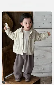 Detail of toddler spring set featuring light beige jacket and lavender casual pants