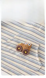 Close-up of baby striped polo shirt featuring a 3D cartoon car embroidery and buttons